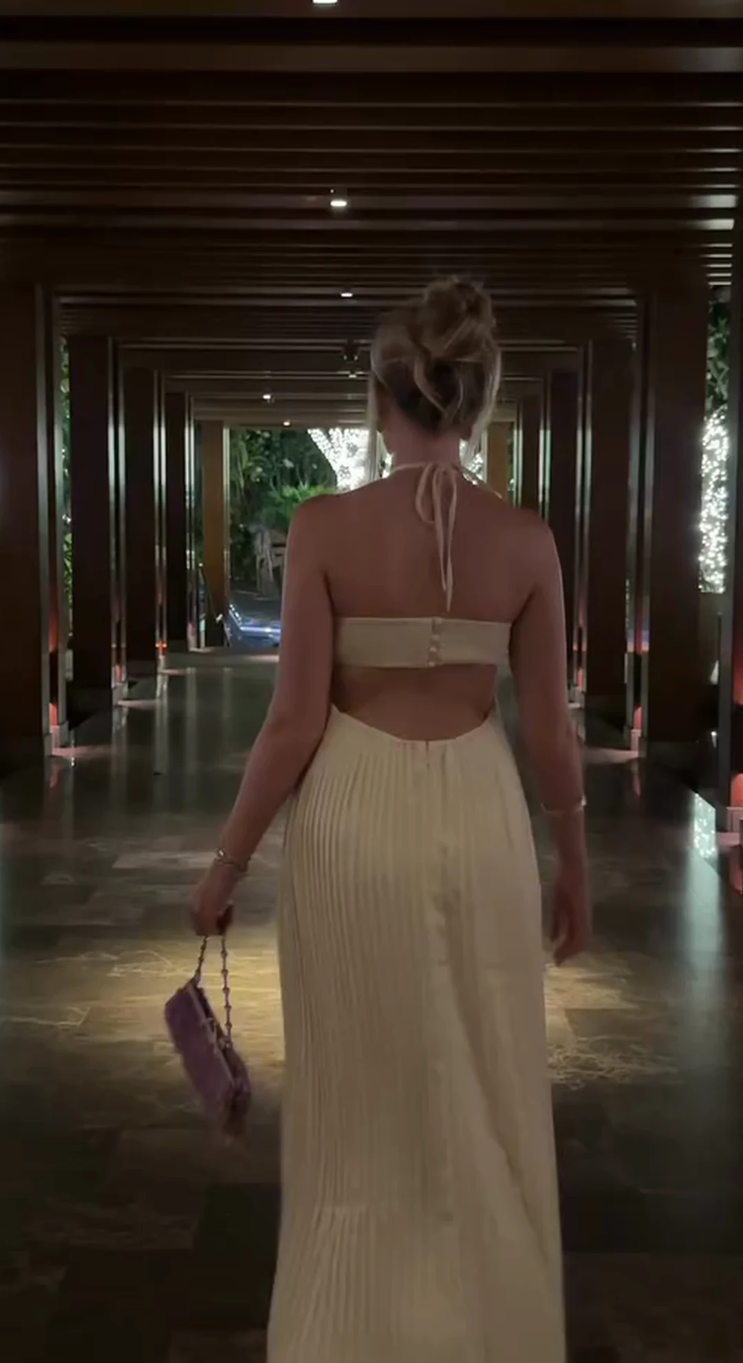 Cream evening dress in an Andaz corridor